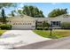 Charming single-story home featuring a well-manicured lawn, beautiful landscaping, and an attached two-car garage at 1530 Ingram Dr # 1530, Sun City Center, FL 33573
