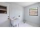 Laundry room with sink, tile flooring, window, and a door to the exterior at 1530 Ingram Dr # 1530, Sun City Center, FL 33573