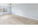 Bright living room with light wood floors and a ceiling fan, offering a versatile and welcoming space at 1530 Ingram Dr # 1530, Sun City Center, FL 33573