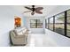 Bright sunroom with large windows and ceiling fan, offering a serene spot to enjoy the outdoors from inside at 1530 Ingram Dr # 1530, Sun City Center, FL 33573