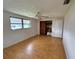 Bright bedroom with large windows, wood flooring, and a standard closet at 1542 Derrick St, Holiday, FL 34690
