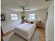 Cozy bedroom with ceiling fan, neutral walls, two windows with blinds, and hardwood floors at 1542 Derrick St, Holiday, FL 34690
