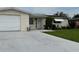 Charming home with a well-manicured front yard, clean driveway, and inviting entryway, creating great curb appeal at 1542 Derrick St, Holiday, FL 34690