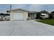 Charming single-story home featuring a one-car garage, well-maintained lawn, and a welcoming front entrance at 1542 Derrick St, Holiday, FL 34690