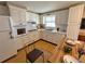 Bright kitchen featuring white cabinets, wooden floors, stainless steel appliances, and modern countertops at 1542 Derrick St, Holiday, FL 34690