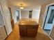 Bright, open kitchen featuring laminate wood floors, lots of cabinet storage, and flows into the living room at 1542 Derrick St, Holiday, FL 34690