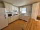 Bright kitchen with white cabinets, laminate countertops, and stainless steel appliances at 1542 Derrick St, Holiday, FL 34690