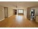 Open-concept living room featuring wood laminate floors, neutral walls, and lots of natural light at 1542 Derrick St, Holiday, FL 34690