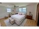 Tranquil main bedroom with large window, ceiling fan, a decorative rug, and light colored walls at 1542 Derrick St, Holiday, FL 34690