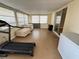 Inviting sunroom with natural light, comfortable seating, and space for a treadmill, perfect for relaxation and fitness at 1542 Derrick St, Holiday, FL 34690