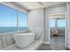 Bright bathroom features a modern tub and mosaic floors offering stunning ocean views from large windows at 1600 Gulf Blvd # 1112, Clearwater Beach, FL 33767