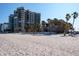 Expansive beachfront property featuring a high-rise condo community and palm trees at 1600 Gulf Blvd # 1112, Clearwater Beach, FL 33767
