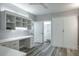 This bedroom features a stylish built-in desk with shelves and cabinets, plus a murphy bed for extra space at 1600 Gulf Blvd # 1112, Clearwater Beach, FL 33767