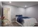 Cozy bedroom featuring wood floors and a full bed with stylish blue-and-white bedding at 1600 Gulf Blvd # 1112, Clearwater Beach, FL 33767
