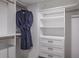 Organized closet featuring built-in shelves, drawers, and gold hardware, along with hanging storage at 1600 Gulf Blvd # 1112, Clearwater Beach, FL 33767