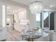 Bright modern kitchen with white cabinets, stainless steel appliances, and ocean view dining area at 1600 Gulf Blvd # 1112, Clearwater Beach, FL 33767