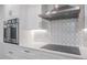 Modern kitchen with stainless steel appliances and geometric backsplash at 1600 Gulf Blvd # 1112, Clearwater Beach, FL 33767