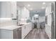 Open concept kitchen with stainless steel appliances and white cabinets, leading to dining and living areas at 1600 Gulf Blvd # 1112, Clearwater Beach, FL 33767