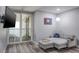Comfortable living room features a modern couch, mounted TV, and a balcony with water views at 1600 Gulf Blvd # 1112, Clearwater Beach, FL 33767