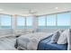 Bright bedroom featuring ocean views, hardwood floors, ceiling fan and a comfortable bed at 1600 Gulf Blvd # 1112, Clearwater Beach, FL 33767