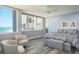 Bright bedroom featuring ocean views, hardwood floors, ceiling fan and sitting area at 1600 Gulf Blvd # 1112, Clearwater Beach, FL 33767