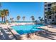 Serene pool view overlooking the ocean with several palm trees and lounge chairs at 1600 Gulf Blvd # 1112, Clearwater Beach, FL 33767