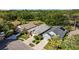 Aerial view showcasing well-manicured lawns and mature trees surrounding properties at 18631 Le Dauphine Pl, Lutz, FL 33558