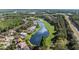Beautiful aerial view of a residential area alongside a scenic golf course and a tranquil body of water at 18631 Le Dauphine Pl, Lutz, FL 33558