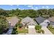 Aerial view of a well-maintained home with manicured lawn, landscaping and mature trees at 18631 Le Dauphine Pl, Lutz, FL 33558