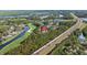 This aerial view showcases a neighborhood with a golf course, several ponds and nearby highway at 18631 Le Dauphine Pl, Lutz, FL 33558