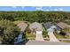 Aerial view of a charming home with landscaped yard, driveway and mature trees at 18631 Le Dauphine Pl, Lutz, FL 33558