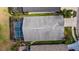 Aerial of home with screened in pool and view of the backyard, roofing, landscaping and street access at 18631 Le Dauphine Pl, Lutz, FL 33558