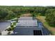 Overhead view highlighting the pool areas of homes surrounded by green space and trees at 18631 Le Dauphine Pl, Lutz, FL 33558