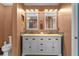 Elegant bathroom featuring double vanity with marble countertop and ample cabinet space at 18631 Le Dauphine Pl, Lutz, FL 33558