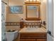 Bathroom with a framed mirror, vanity, and stylish fixtures, complete with tile backsplash at 18631 Le Dauphine Pl, Lutz, FL 33558