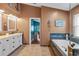 Relaxing bathroom offering a garden tub and a vanity with great natural light at 18631 Le Dauphine Pl, Lutz, FL 33558