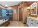 Spacious bathroom with a garden tub, glass-enclosed shower, and dual sink vanity at 18631 Le Dauphine Pl, Lutz, FL 33558