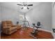 Bonus room with exercise equipment, chair, and hardwood floors for workout or leisure at 18631 Le Dauphine Pl, Lutz, FL 33558