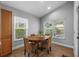 Cozy breakfast nook with a round table, woven chairs, and lots of natural light at 18631 Le Dauphine Pl, Lutz, FL 33558