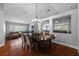 Dining room with hardwood floors, chandelier and view of the living and sitting rooms at 18631 Le Dauphine Pl, Lutz, FL 33558