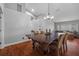 Elegant dining room featuring a chandelier, a large wooden table, and wood floors at 18631 Le Dauphine Pl, Lutz, FL 33558