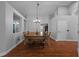Formal dining room featuring hardwood floors, chandelier, and large dining table at 18631 Le Dauphine Pl, Lutz, FL 33558