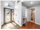 Home foyer with decorative front door and ceramic tiled floor at 18631 Le Dauphine Pl, Lutz, FL 33558