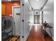 Hallway featuring wood floor and entry to utility room and home entry at 18631 Le Dauphine Pl, Lutz, FL 33558
