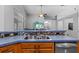 Traditional style kitchen features stainless steel sink and mosaic tile backsplash at 18631 Le Dauphine Pl, Lutz, FL 33558