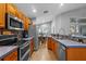Traditional style kitchen features wooden cabinets, stainless steel appliances and blue countertops at 18631 Le Dauphine Pl, Lutz, FL 33558