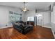 Inviting living room with a ceiling fan, black leather recliners, and wood floors at 18631 Le Dauphine Pl, Lutz, FL 33558