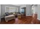 Comfortable living room featuring hardwood floors, a sectional couch, and lots of natural light at 18631 Le Dauphine Pl, Lutz, FL 33558