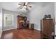 Home office featuring wood floors, ceiling fan and traditional wood furniture set at 18631 Le Dauphine Pl, Lutz, FL 33558