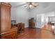 Home office with wood floors, ceiling fan and traditional wood furniture set with computer at 18631 Le Dauphine Pl, Lutz, FL 33558